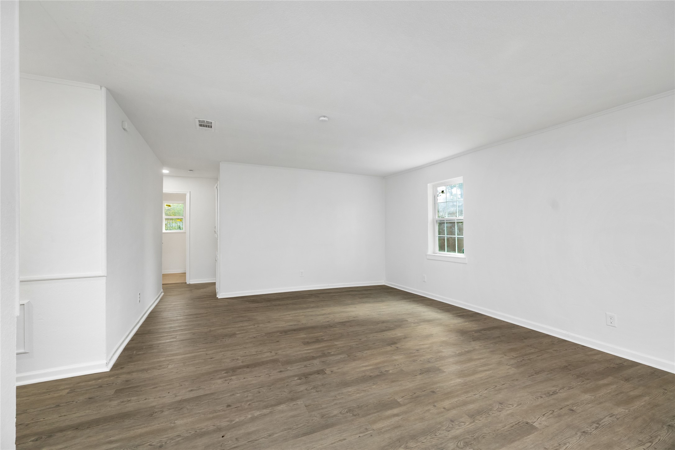 9322 Nyssa Street Houston, TX 77078 - Photo 18 of 34 a view of an empty room with window and wooden floor