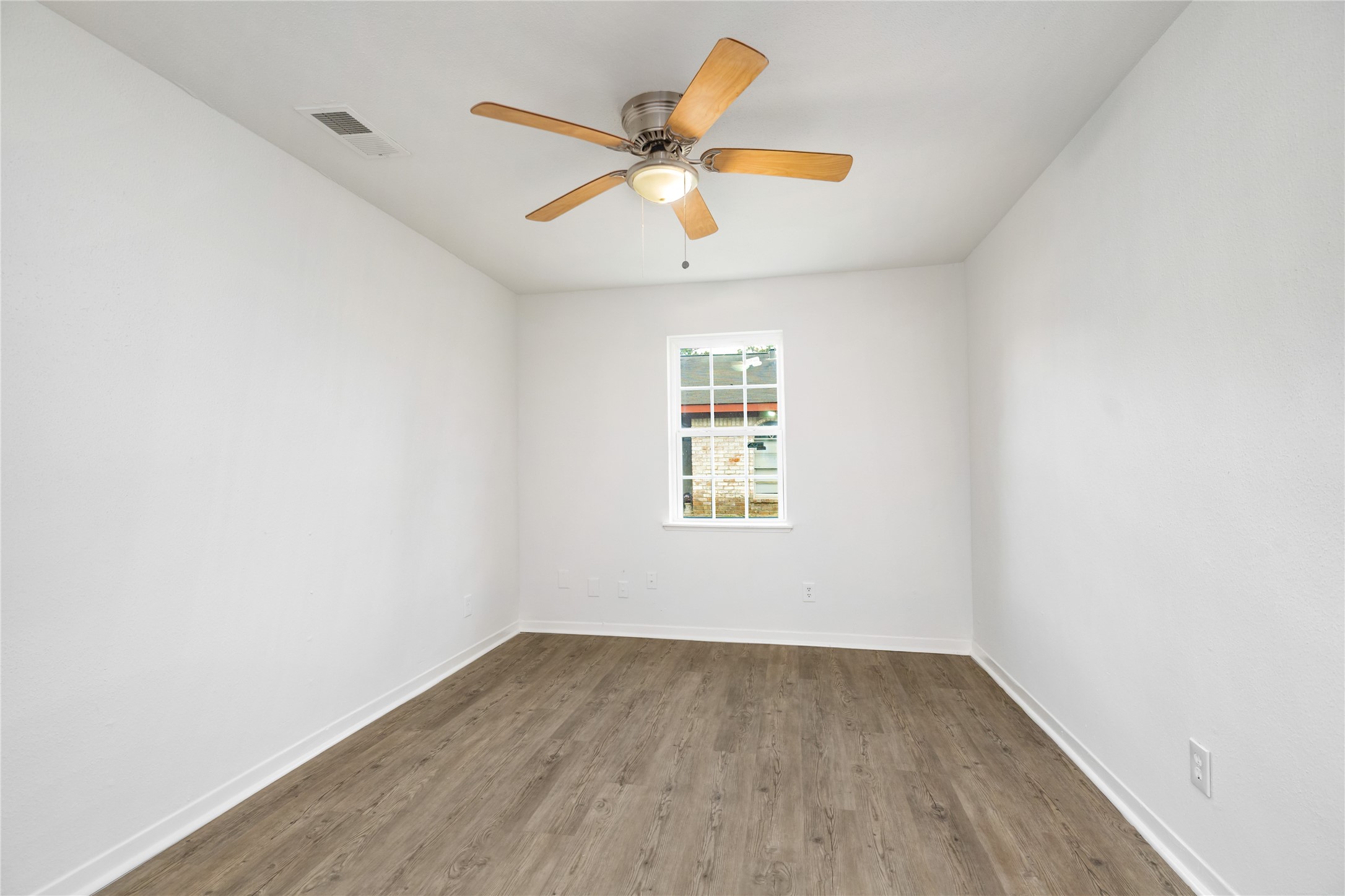 9322 Nyssa Street Houston, TX 77078 - Photo 30 of 34 an empty room with a window and a ceiling fan
