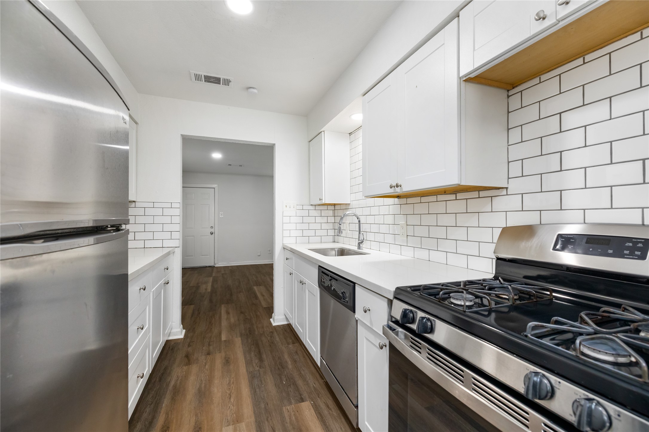 9322 Nyssa Street Houston, TX 77078 - Photo 9 of 34 a kitchen with a stove and a sink