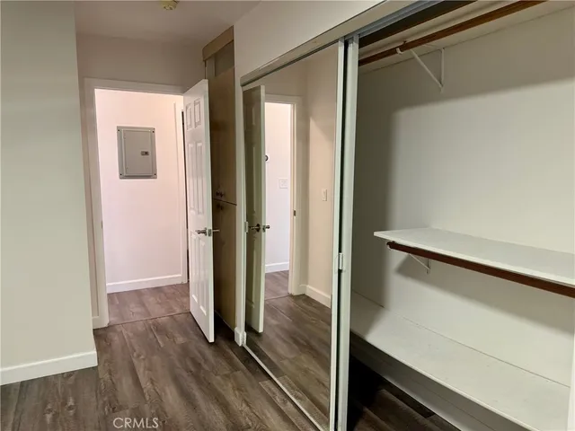 a view of hallway with wooden floor