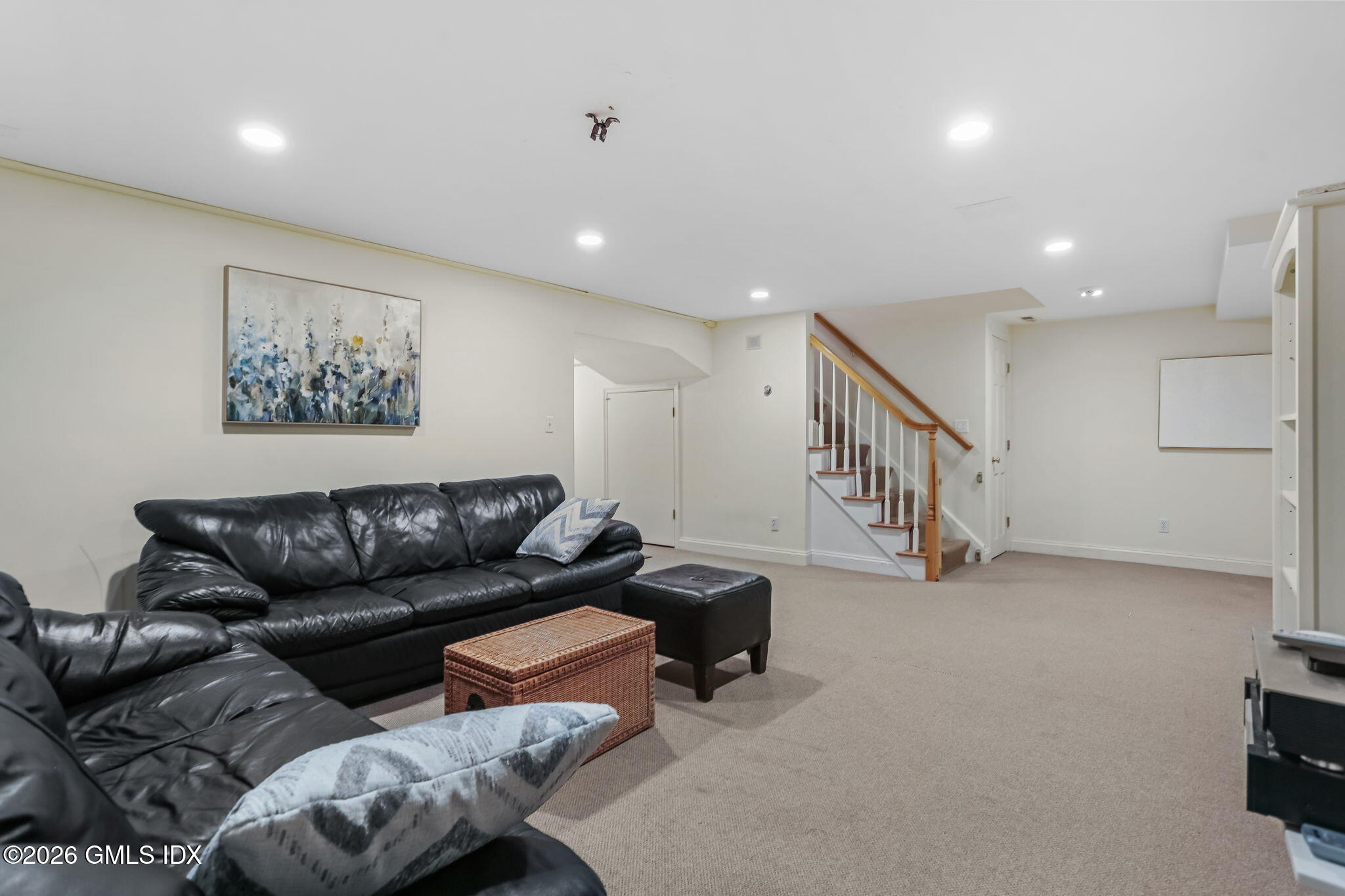 153 Lockwood Road Riverside, CT 06878 - Photo 39 of 58 a living room with furniture and a flat screen tv