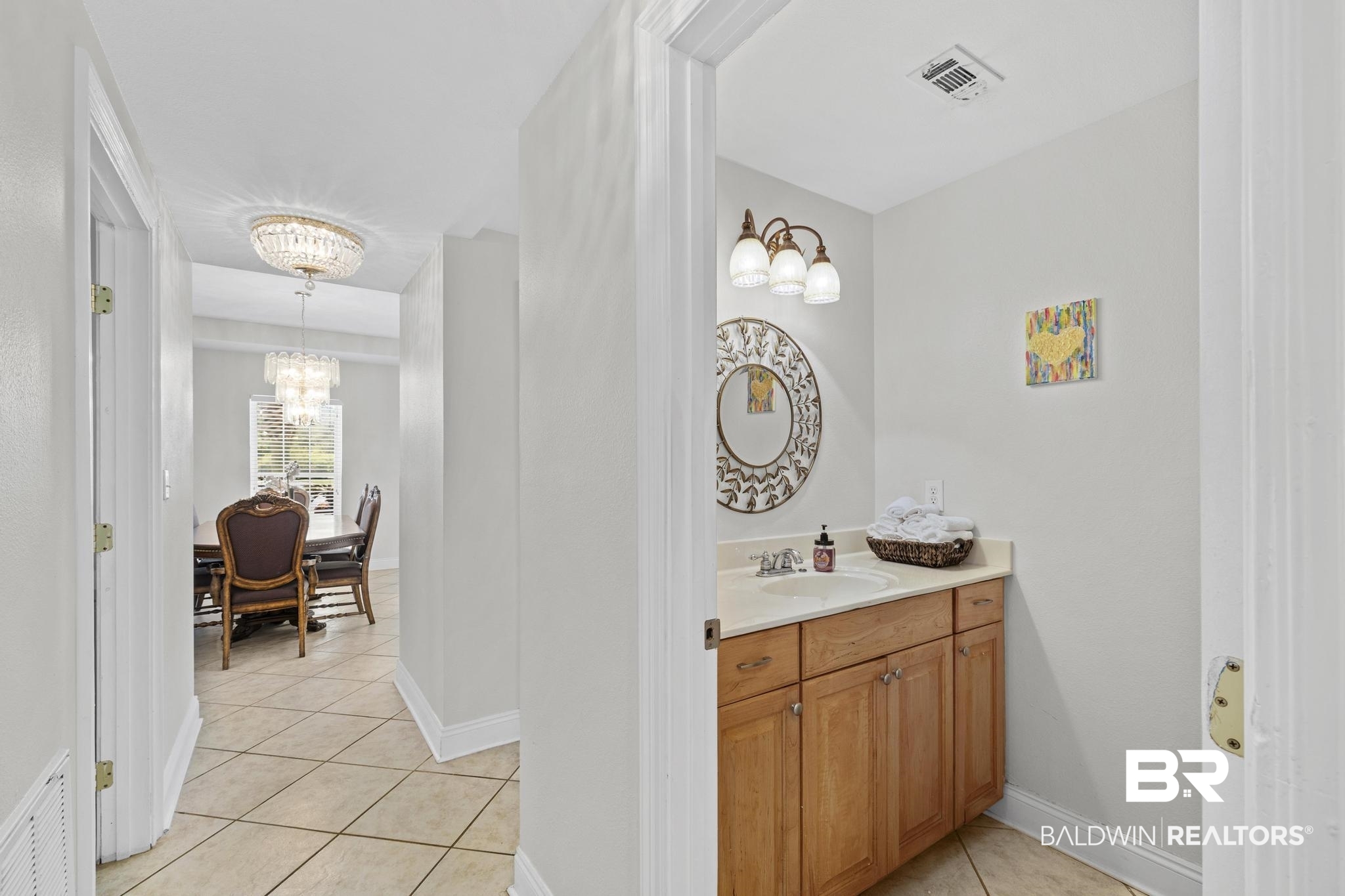 32875 Faircloth Road Lillian, AL 36549 - Photo 32 of 85 Bathroom with vanity, light tile patterned flooring, and a chandelier