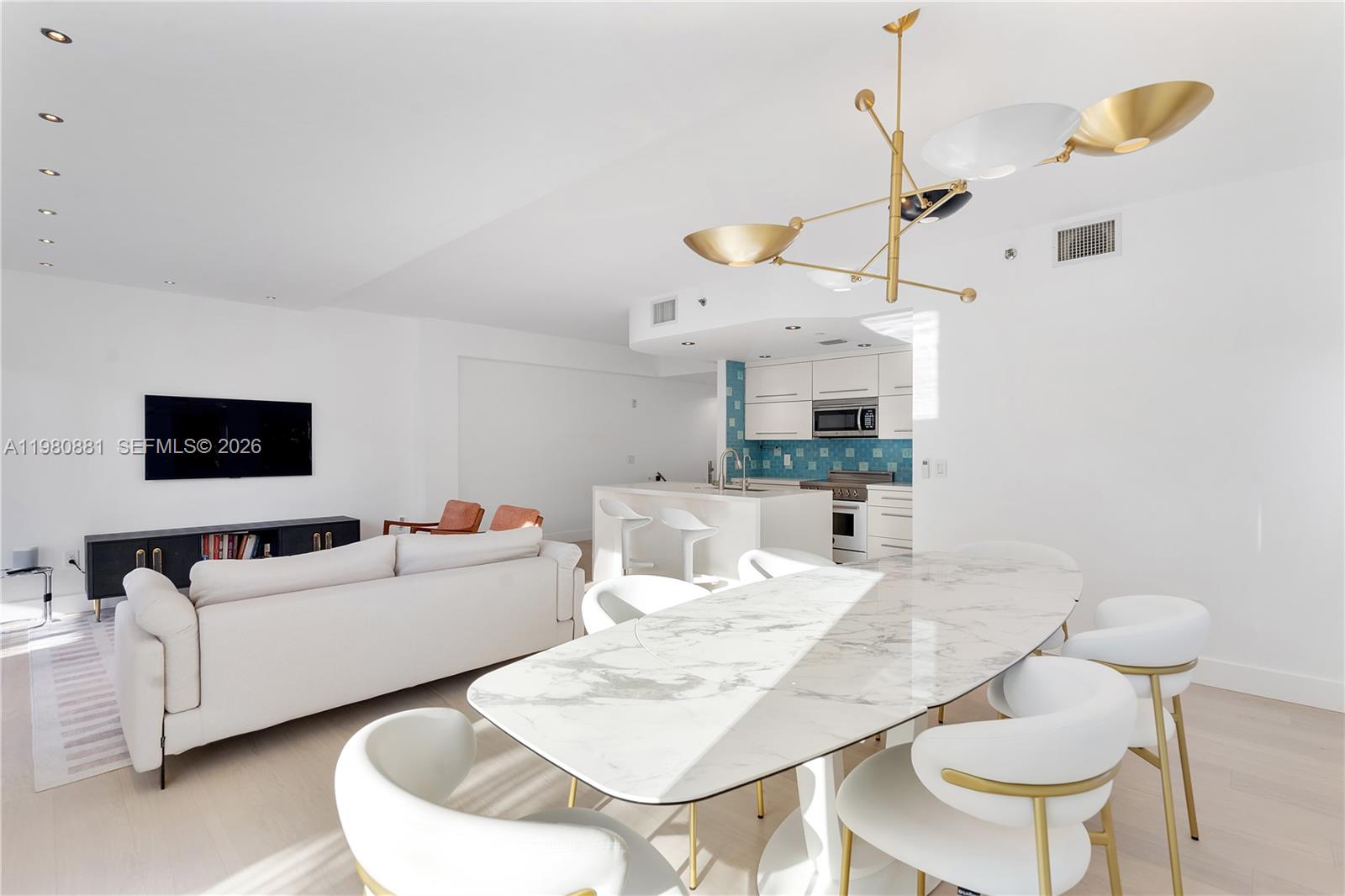 828 3rd Street, Unit 314 Miami Beach, FL 33139 - Photo 13 of 28 a living room with furniture and a flat screen tv
