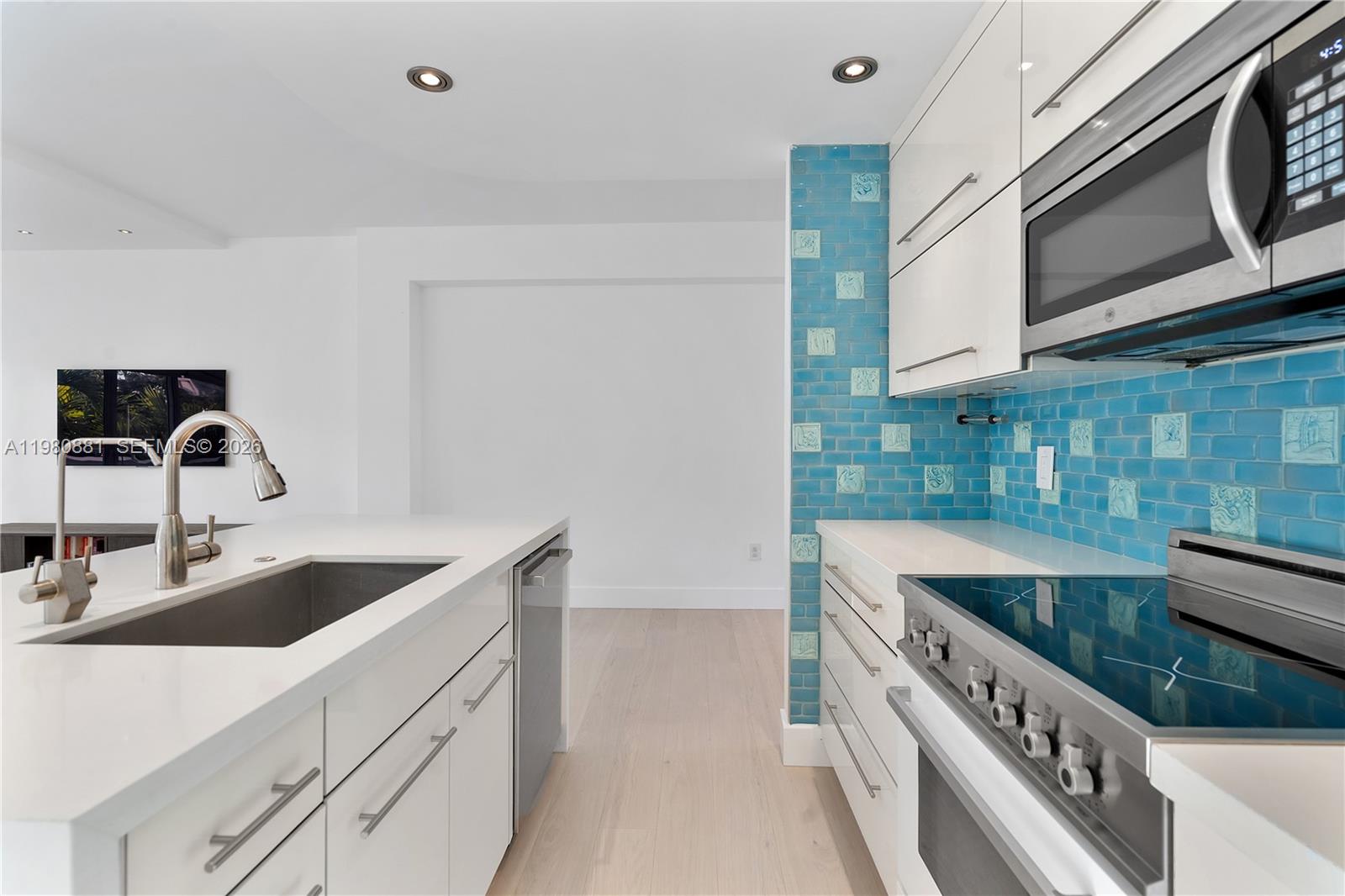 828 3rd Street, Unit 314 Miami Beach, FL 33139 - Photo 15 of 28 a kitchen with stainless steel appliances granite countertop a sink and a stove