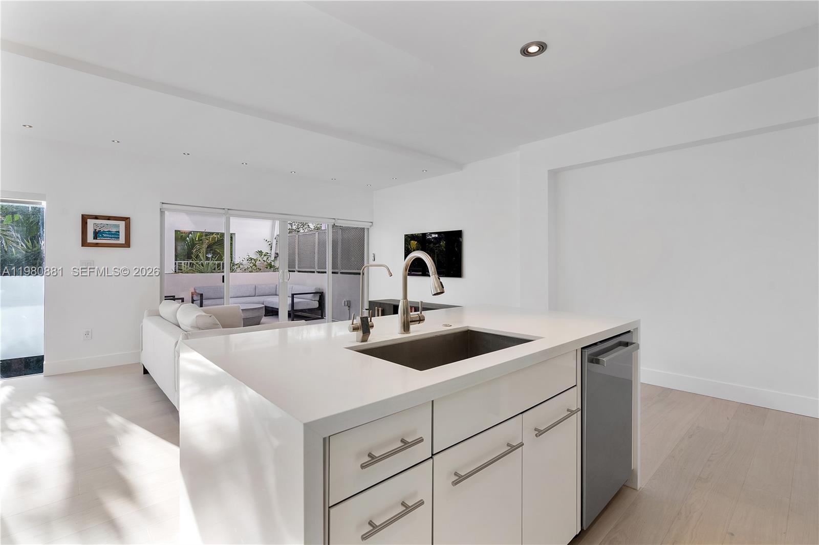 828 3rd Street, Unit 314 Miami Beach, FL 33139 - Photo 16 of 28 a view of a kitchen counter top space with sink and mirror
