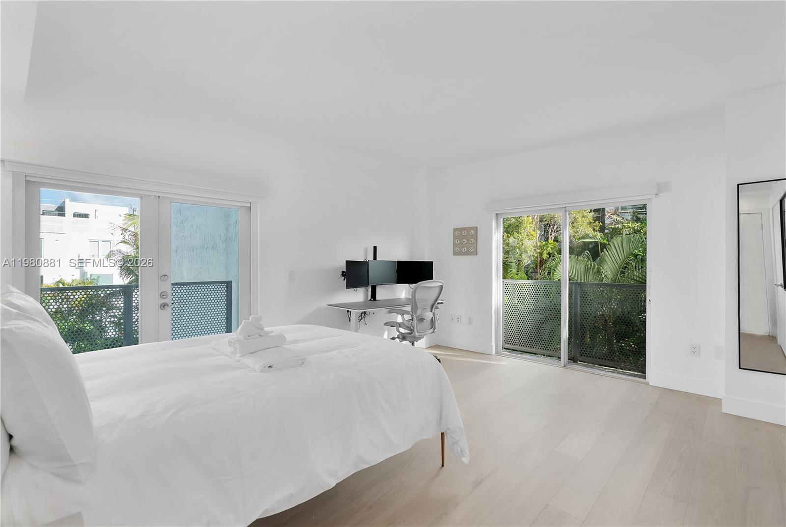 828 3rd Street, Unit 314 Miami Beach, FL 33139 - Photo 17 of 28 a bed sitting in a spacious bedroom next to a window