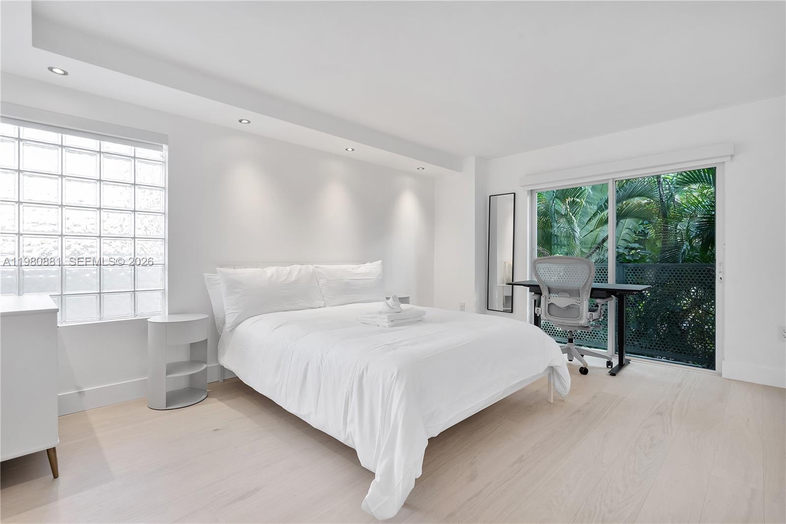 828 3rd Street, Unit 314 Miami Beach, FL 33139 - Photo 19 of 28 a bedroom with a bed and a large window