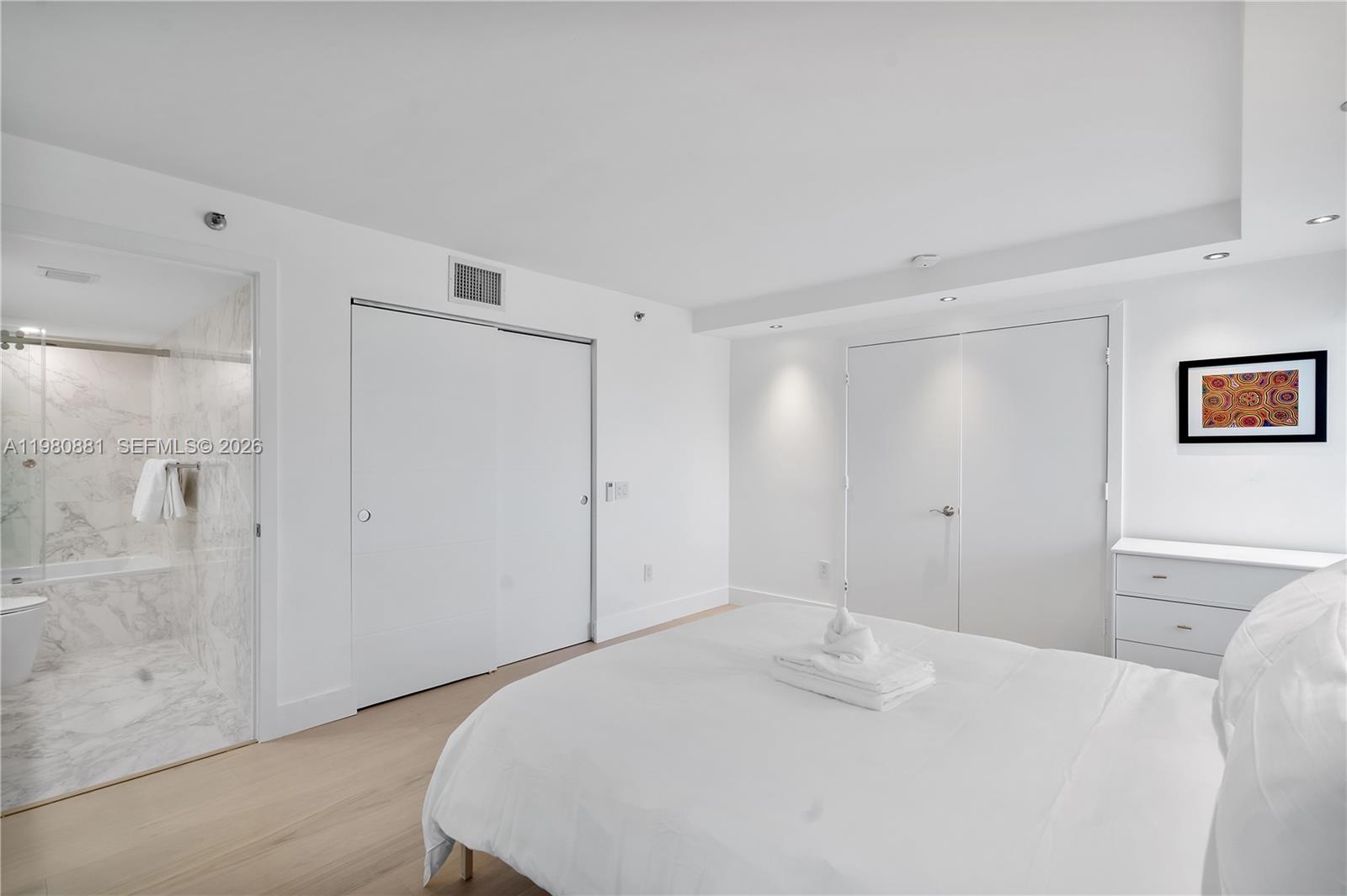 828 3rd Street, Unit 314 Miami Beach, FL 33139 - Photo 20 of 28 a bedroom with a bed and a shower