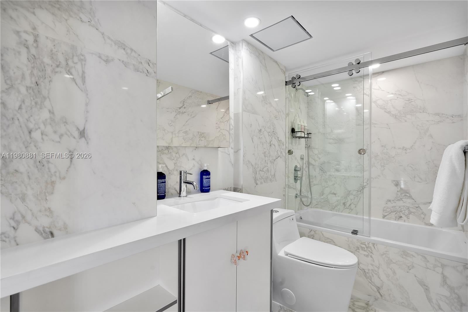 828 3rd Street, Unit 314 Miami Beach, FL 33139 - Photo 21 of 28 a bathroom with a sink vanity granite toilet and shower