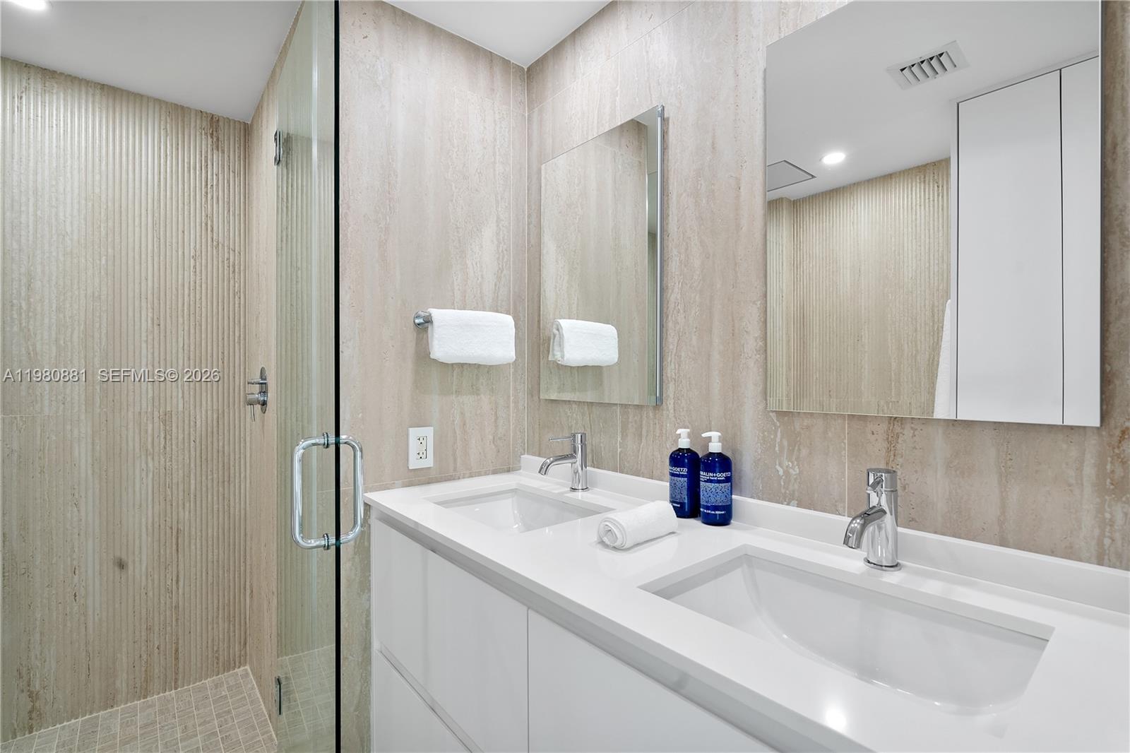 828 3rd Street, Unit 314 Miami Beach, FL 33139 - Photo 22 of 28 a bathroom with a double vanity sink and a mirror