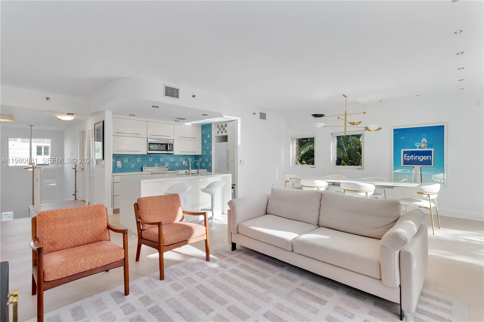 828 3rd Street, Unit 314 Miami Beach, FL 33139 - Photo 3 of 28 a living room with furniture and a wooden floor