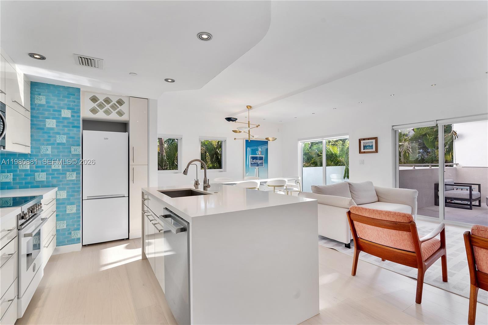 828 3rd Street, Unit 314 Miami Beach, FL 33139 - Photo 5 of 28 a kitchen with a sink a counter top space and stainless steel appliances
