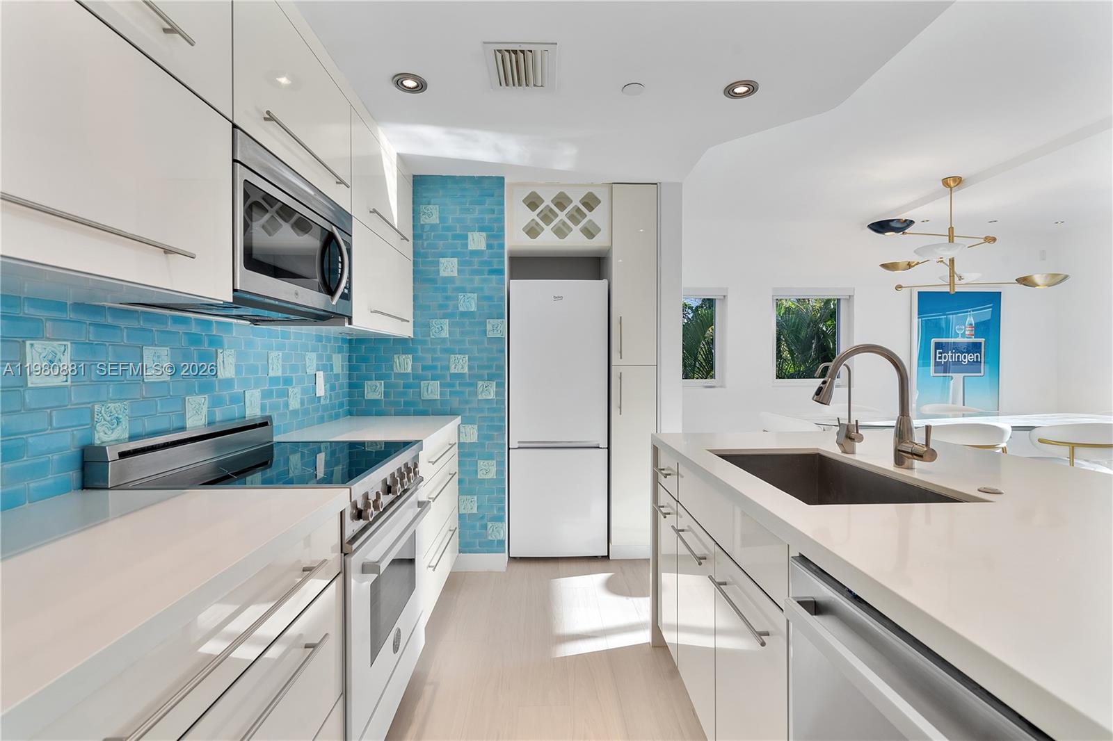 828 3rd Street, Unit 314 Miami Beach, FL 33139 - Photo 8 of 28 a kitchen with stainless steel appliances granite countertop a sink and a microwave