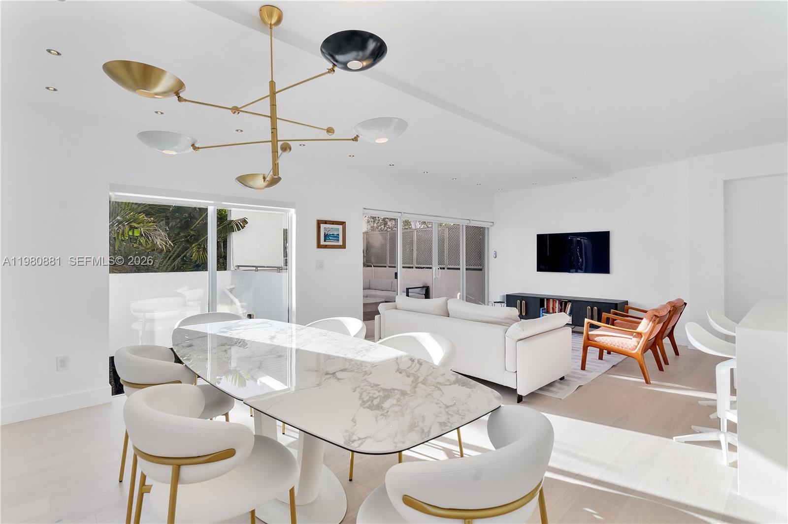 828 3rd Street, Unit 314 Miami Beach, FL 33139 - Photo 10 of 28 a living room with furniture and a flat screen tv