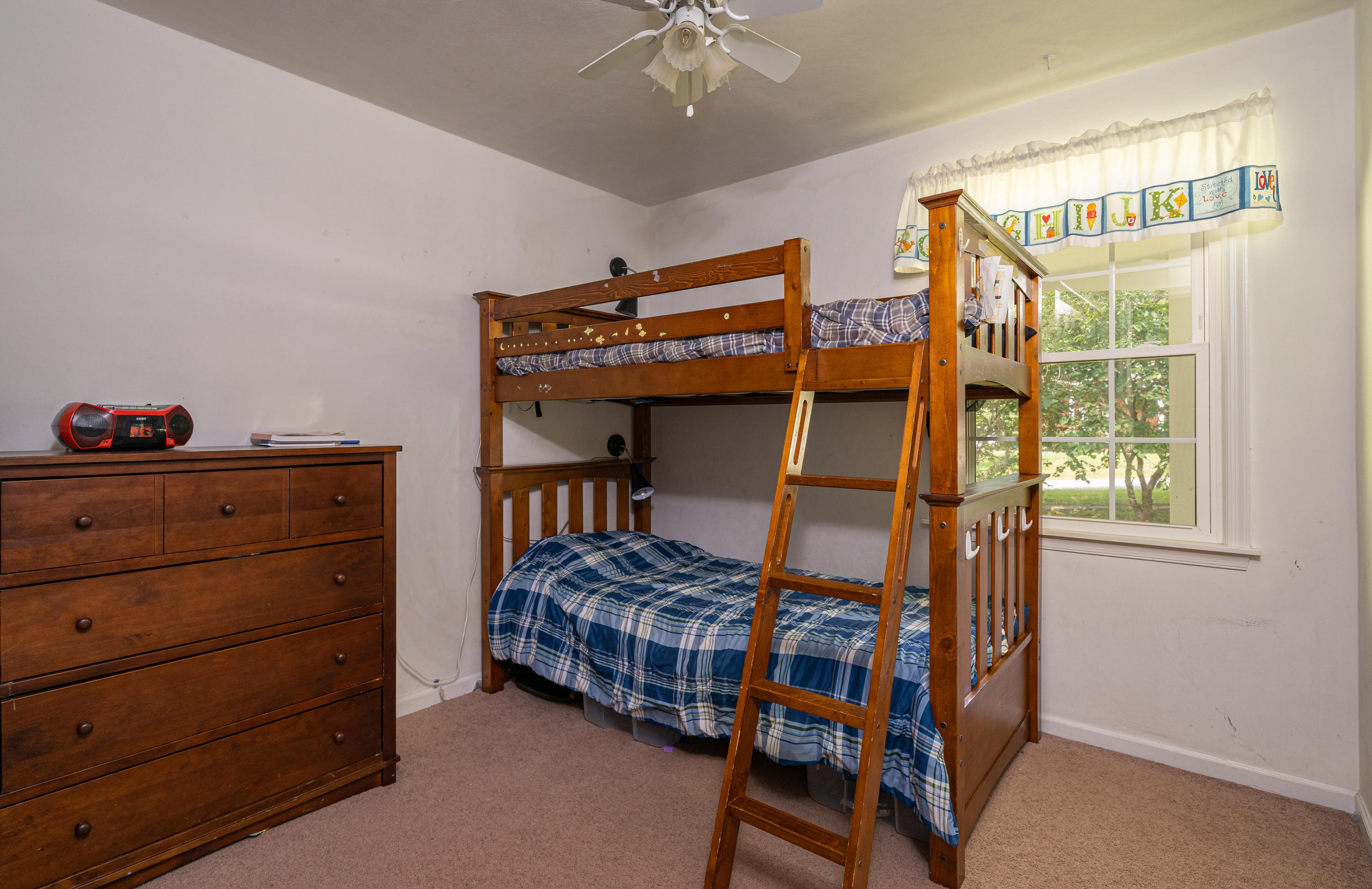 437 Pin Oak Drive Blue Ridge, VA 24064 - Photo 17 of 24 a bedroom with a bed and a chandelier