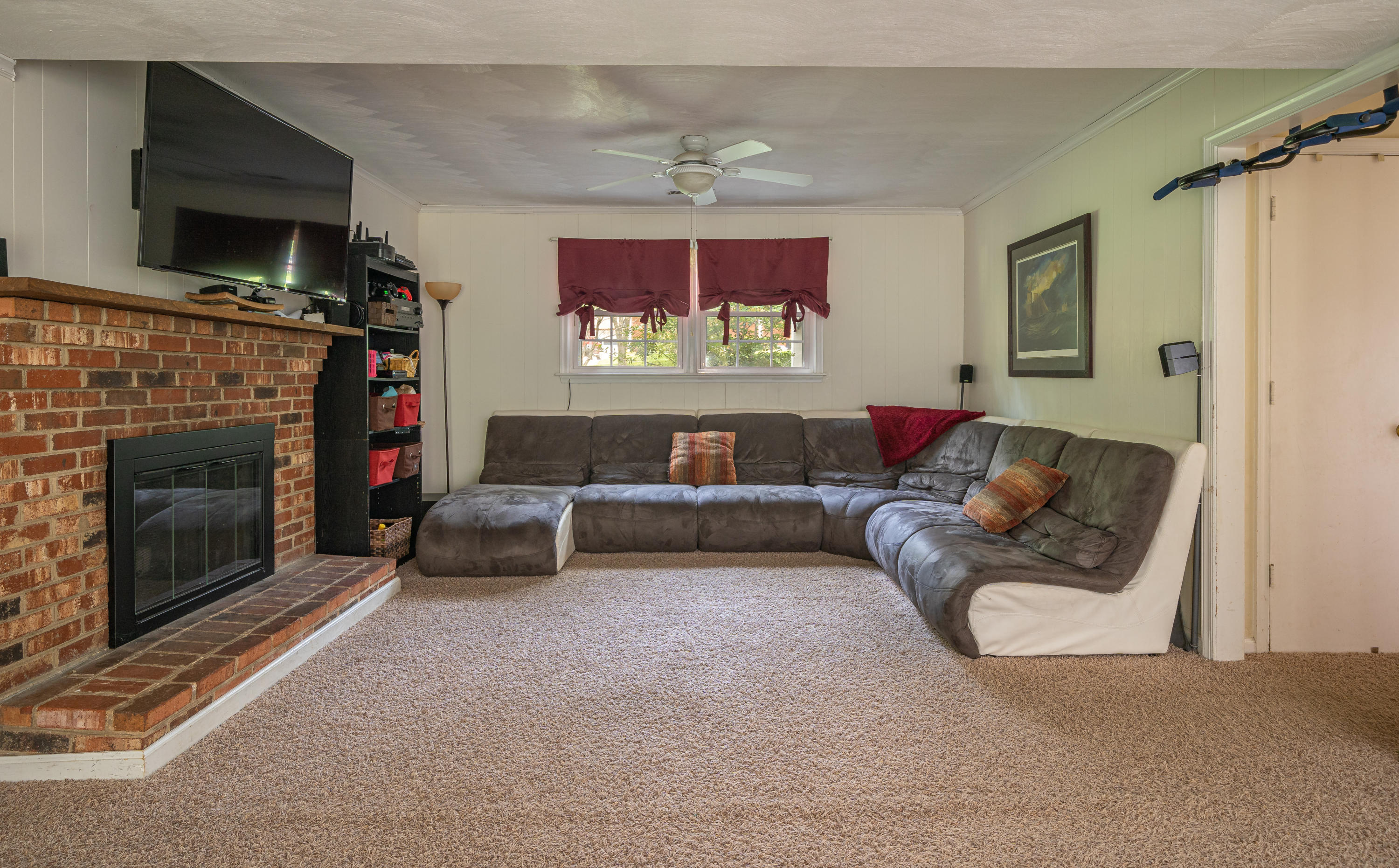 437 Pin Oak Drive Blue Ridge, VA 24064 - Photo 19 of 24 a living room with furniture a flat screen tv and a fireplace