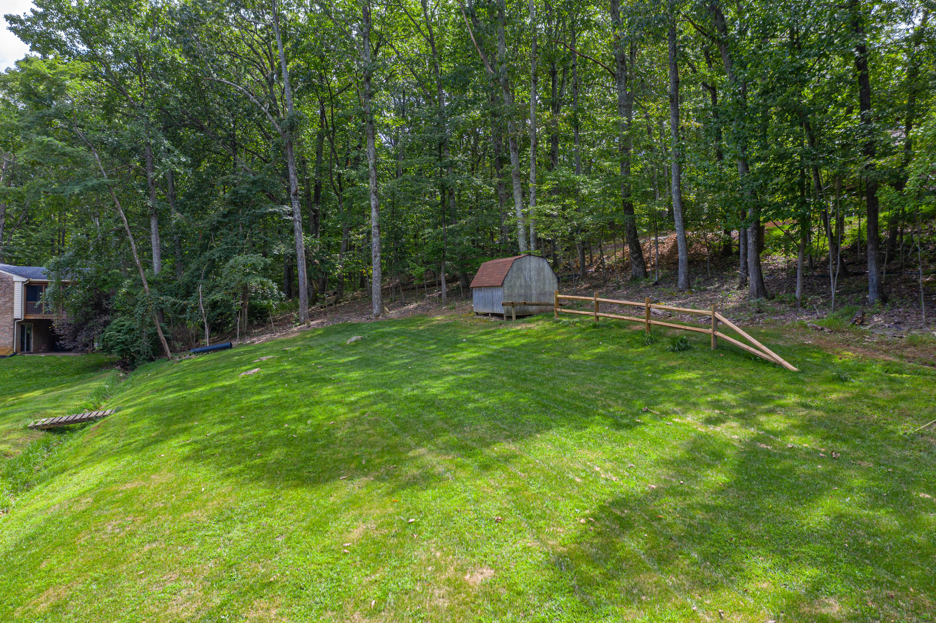 437 Pin Oak Drive Blue Ridge, VA 24064 - Photo 5 of 24 a view of a house with a backyard and a patio