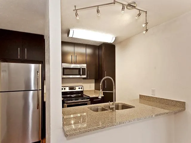 a kitchen with a refrigerator and a sink