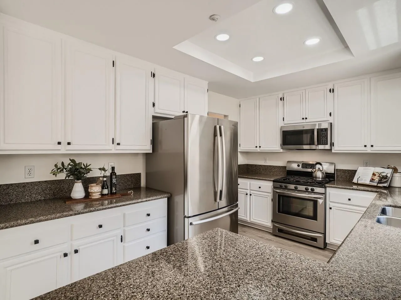 8515 Mesa Heights Road Santee, CA 92071 - Photo 11 of 28 a kitchen with stainless steel appliances white cabinets and a refrigerator