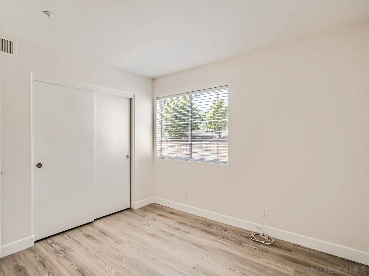8515 Mesa Heights Road Santee, CA 92071 - Photo 15 of 28 an empty room with wooden floor and windows