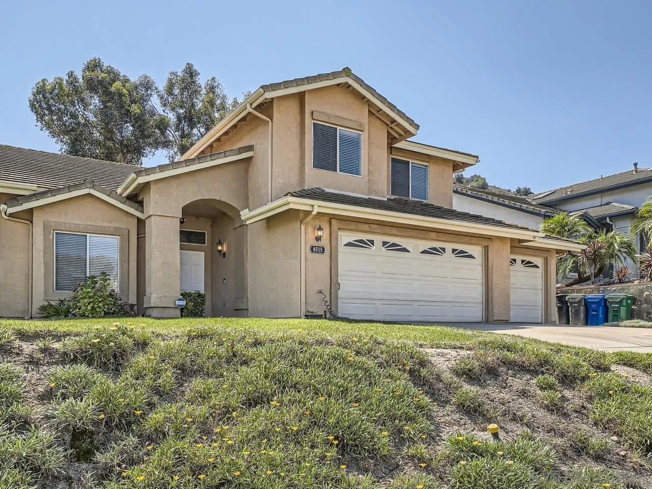 8515 Mesa Heights Road Santee, CA 92071 - Photo 2 of 28 a front view of a house with a yard and garage