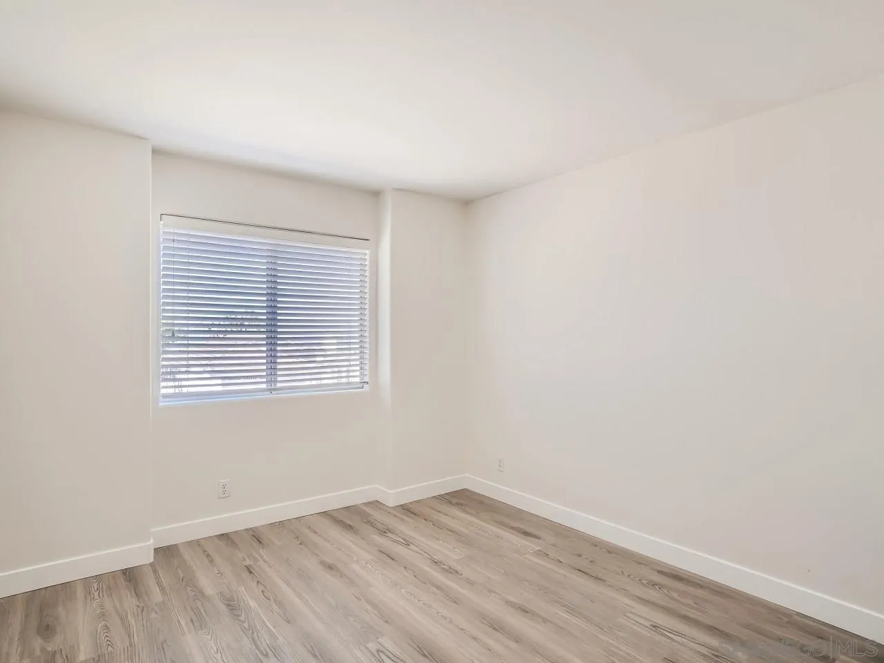 8515 Mesa Heights Road Santee, CA 92071 - Photo 21 of 28 an empty room with wooden floor and a window