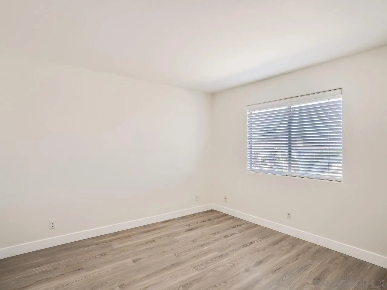 8515 Mesa Heights Road Santee, CA 92071 - Photo 22 of 28 an empty room with wooden floor and windows