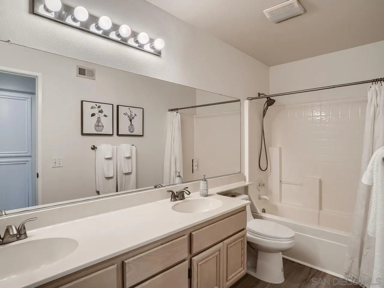 8515 Mesa Heights Road Santee, CA 92071 - Photo 23 of 28 a bathroom with a sink toilet a mirror and shower