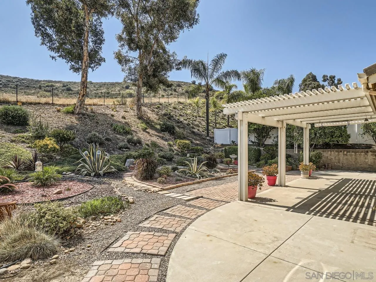 8515 Mesa Heights Road Santee, CA 92071 - Photo 28 of 28 a view of a house with floor to ceiling windows and yard
