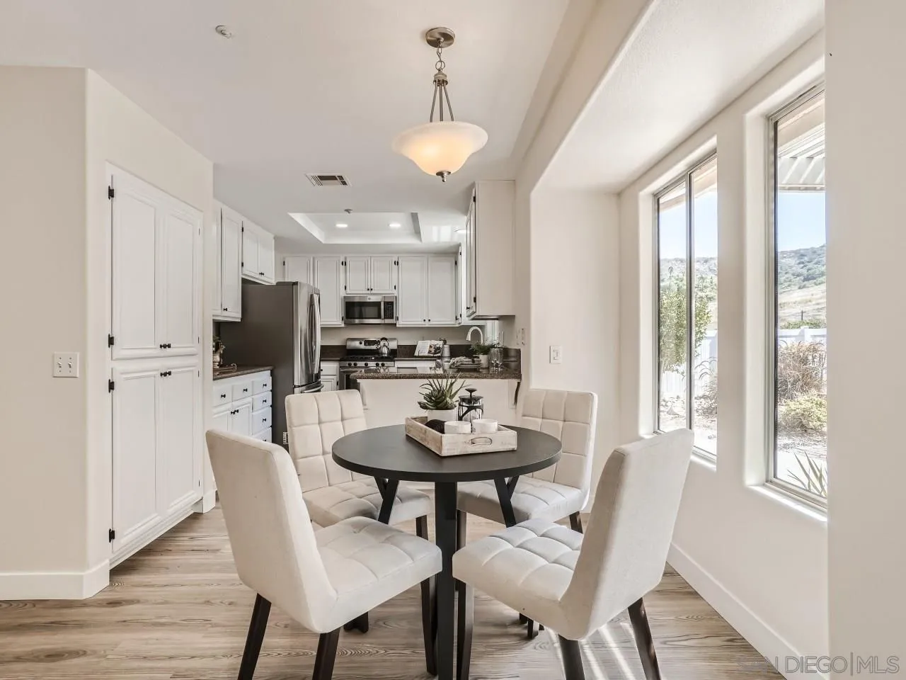 8515 Mesa Heights Road Santee, CA 92071 - Photo 8 of 28 a view of a dining room with furniture and a chandelier