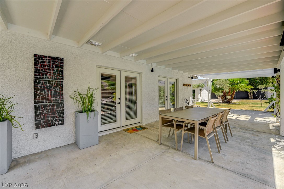 4153 Woodcrest Road Las Vegas, NV 89121 - Photo 44 of 58 An inviting covered patio offers an ideal spot for outdoor dining and relaxation with access to a spacious yard.