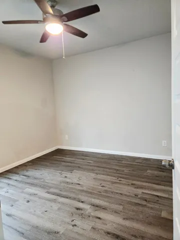 a view of an empty room and wooden floor