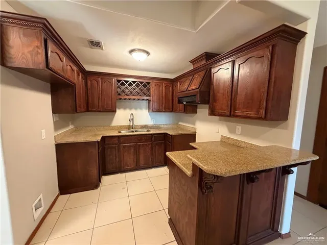a kitchen with a stove a sink and a refrigerator