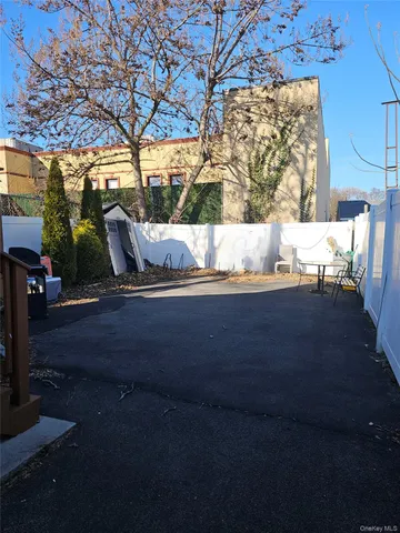 a view of yard along with road and trees