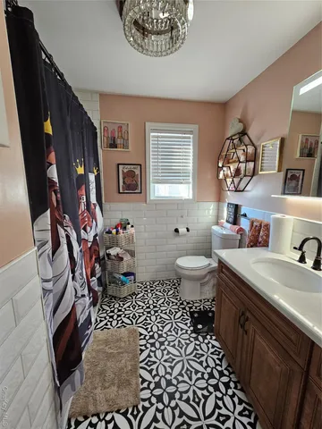 a bathroom with a sink a toilet and a shower