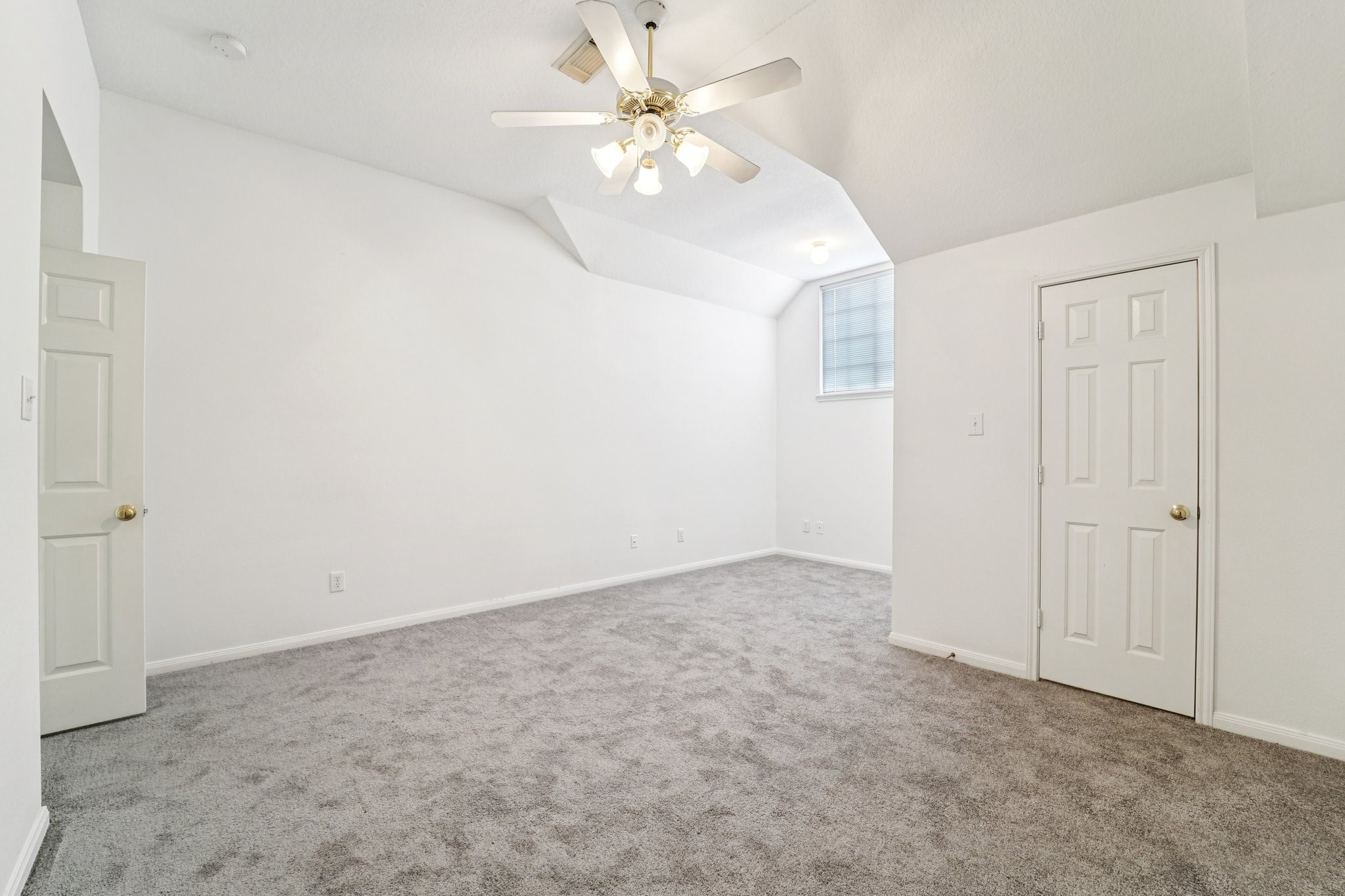 14420 Walters Road, Unit 55 Houston, TX 77014 - Photo 31 of 35 This room features neutral-toned carpeting, a ceiling fan for comfort, and ample natural light from a high window. It includes a small closet and an open doorway, providing a versatile space for various uses.
