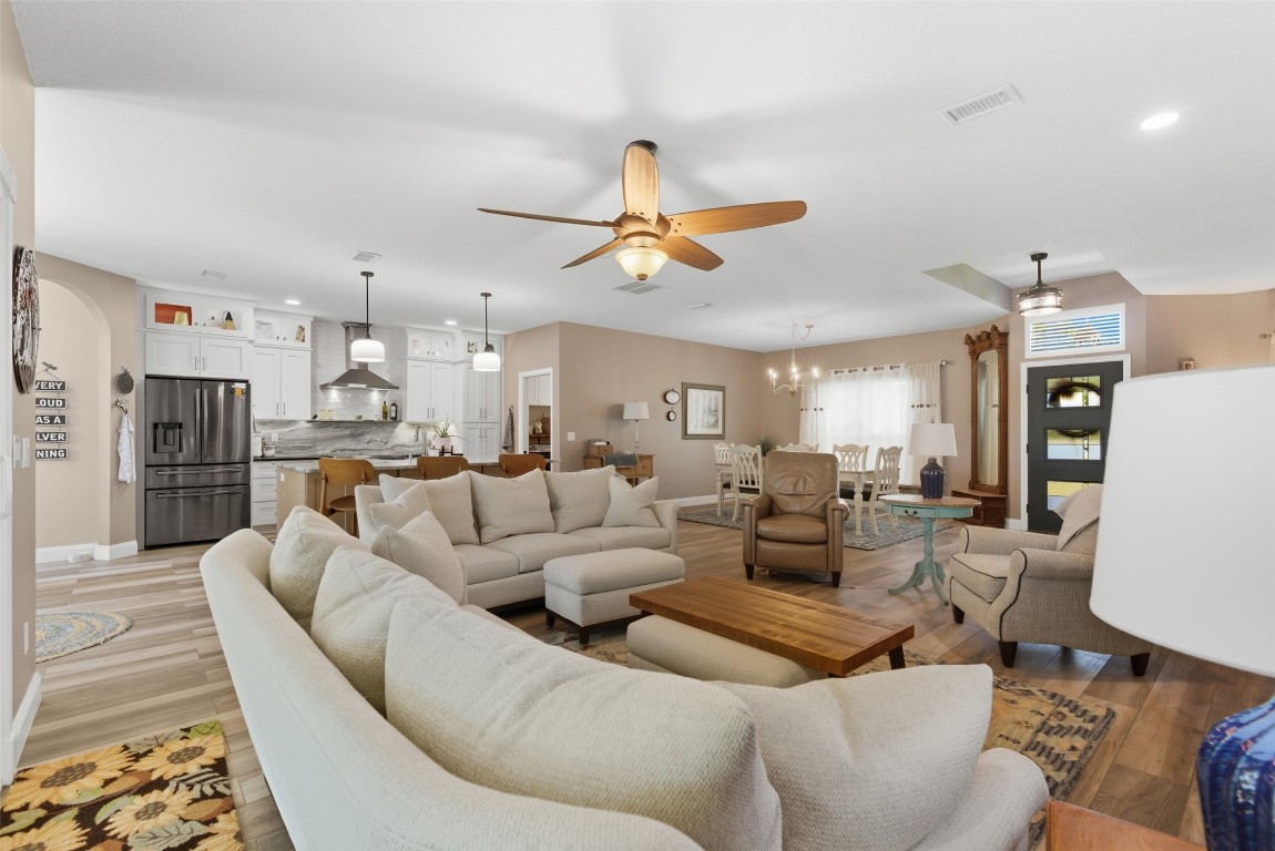 1250 Gum Leaf Road Jacksonville, FL 32226 - Photo 17 of 50 a living room with furniture kitchen view and a chandelier