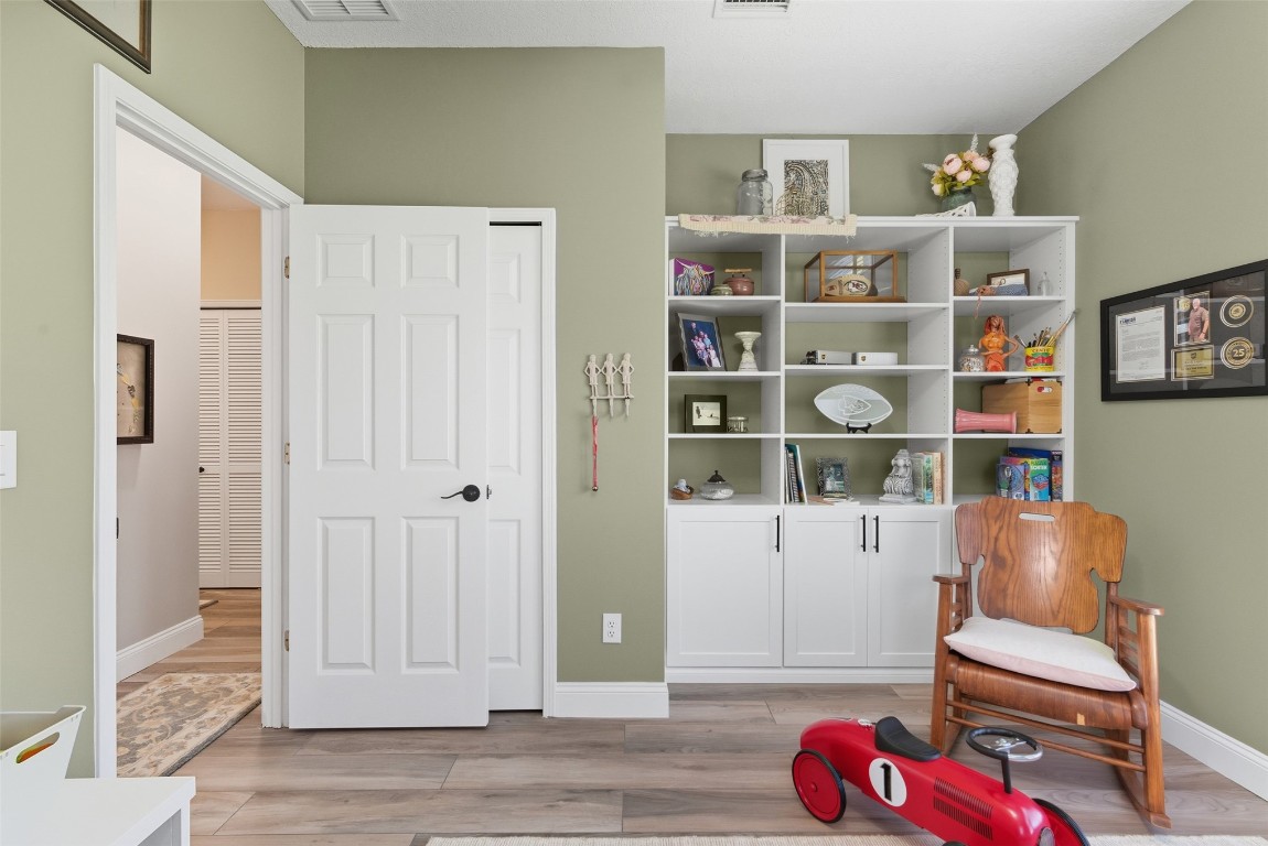 1250 Gum Leaf Road Jacksonville, FL 32226 - Photo 26 of 50 a living room with furniture and a book shelf