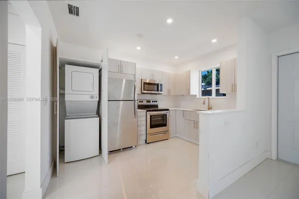 a kitchen with a refrigerator a sink and dishwasher