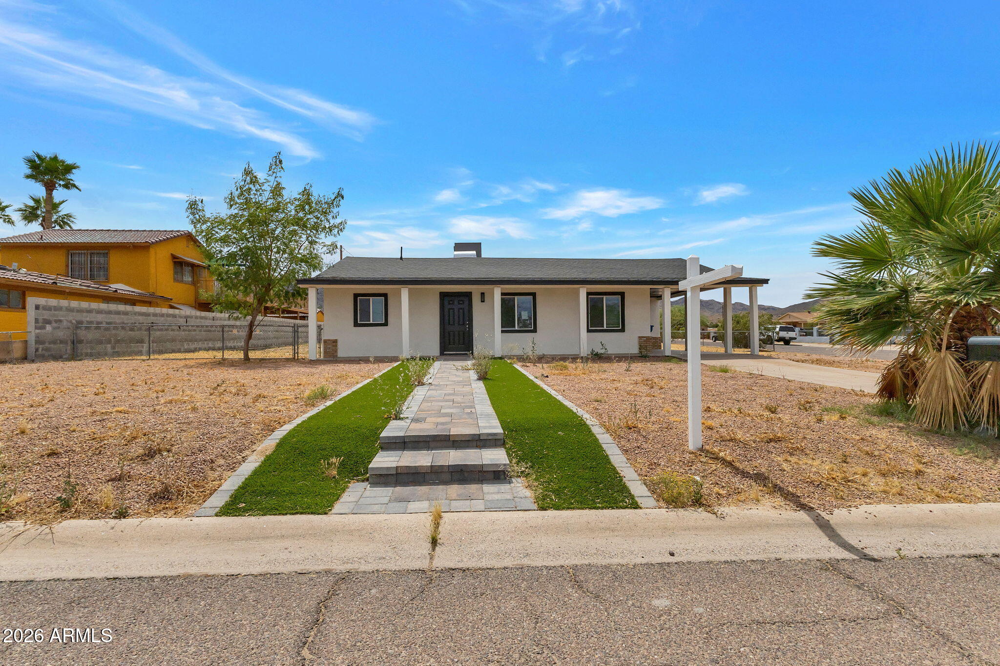 219 West Paseo Way Phoenix, AZ 85041 - Photo 1 of 14 a front view of a house with a yard