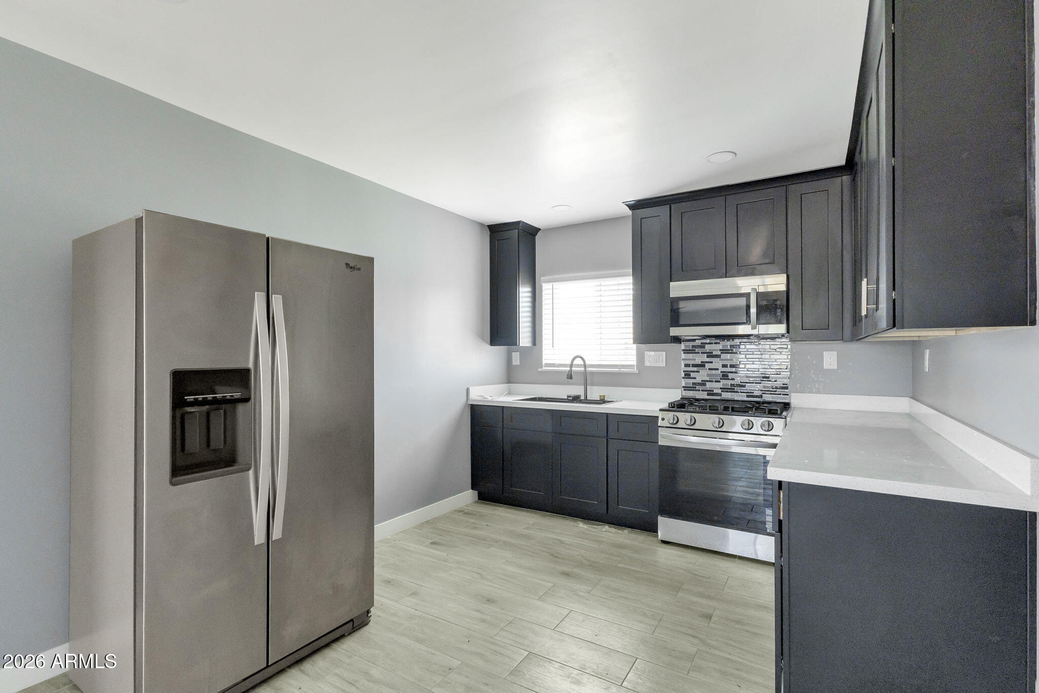 219 West Paseo Way Phoenix, AZ 85041 - Photo 3 of 14 a kitchen with stainless steel appliances granite countertop a refrigerator stove and sink
