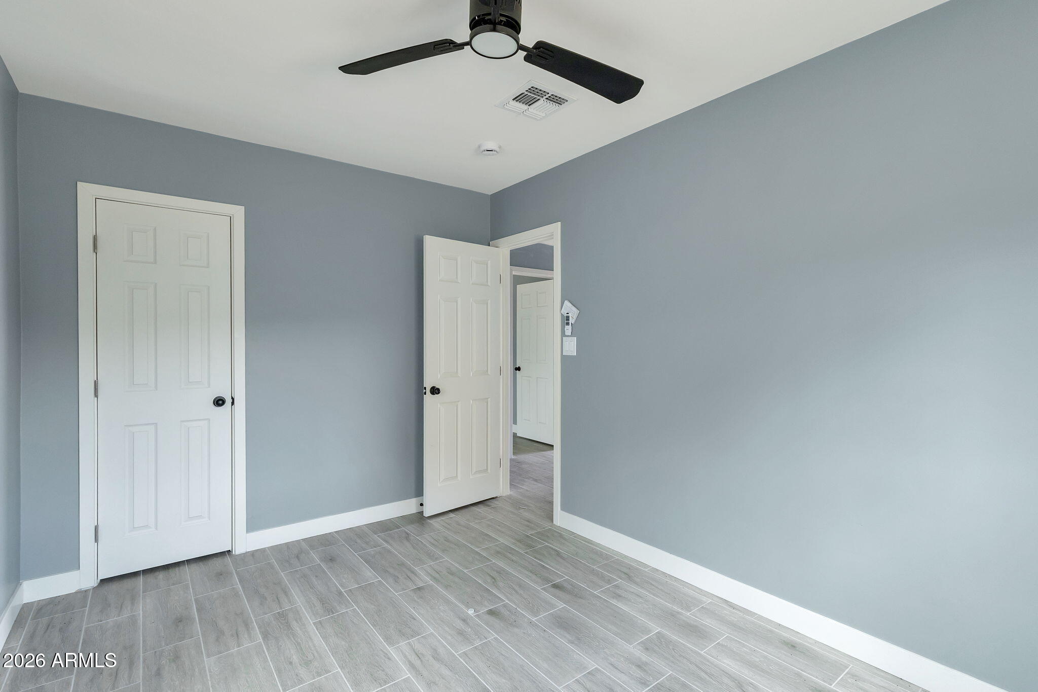 219 West Paseo Way Phoenix, AZ 85041 - Photo 10 of 14 a view of an empty room with wooden floor