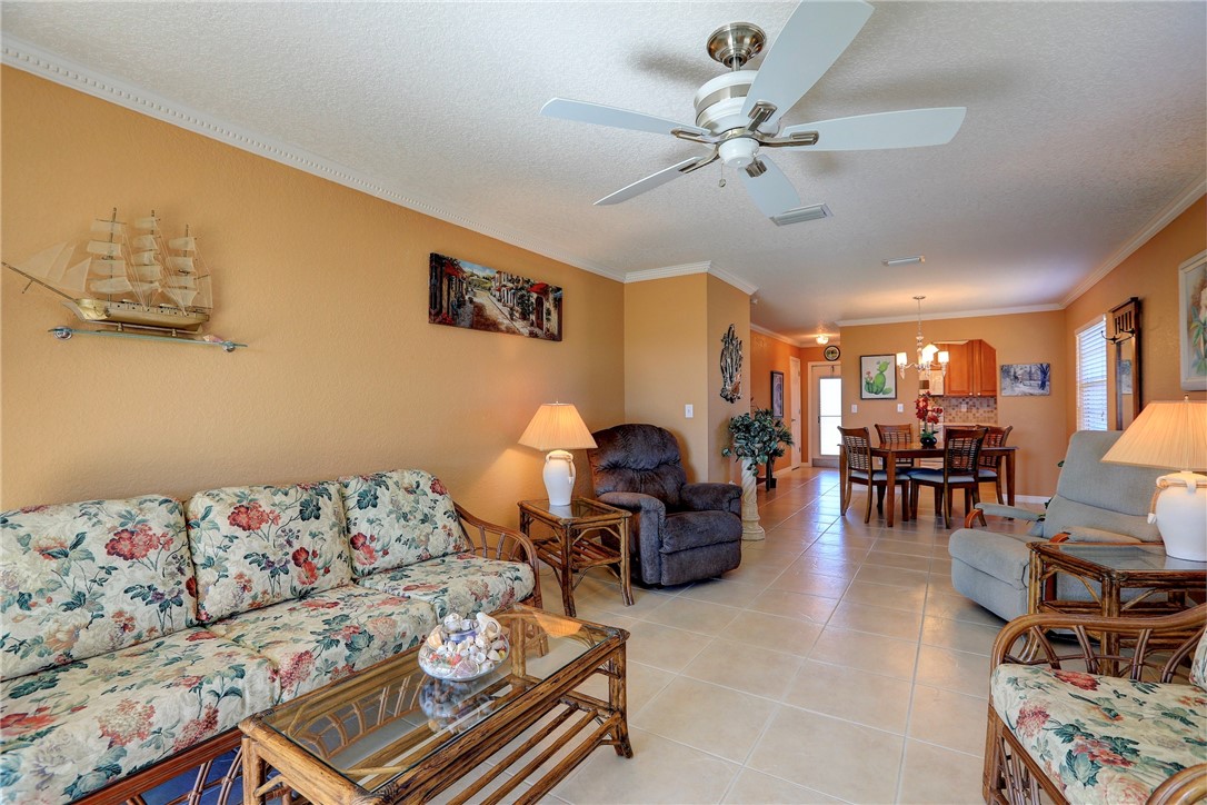 105 Spring Lake Court, Unit 207 Vero Beach, FL 32962 - Photo 11 of 34 a living room with furniture and white walls