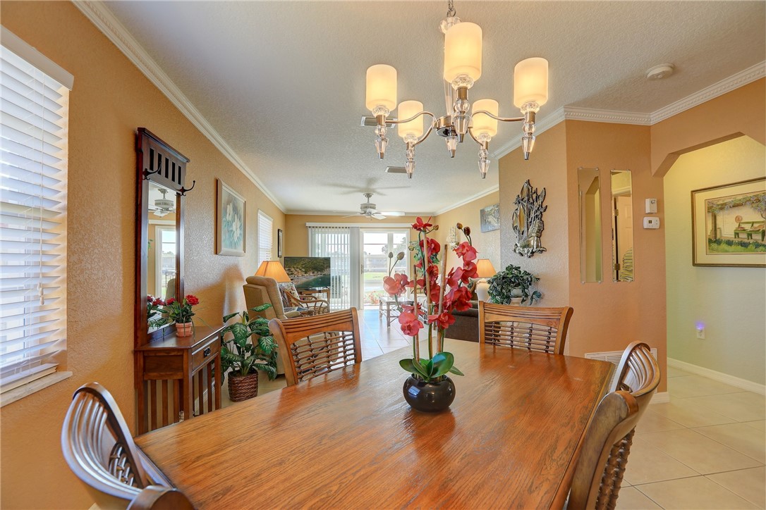 105 Spring Lake Court, Unit 207 Vero Beach, FL 32962 - Photo 12 of 34 a very nice looking dining room with a table and chairs