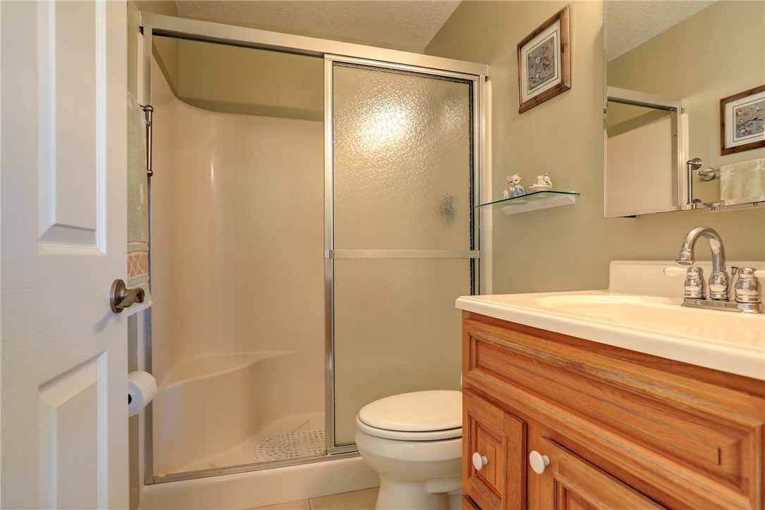 105 Spring Lake Court, Unit 207 Vero Beach, FL 32962 - Photo 15 of 34 a bathroom with a sink a toilet and shower
