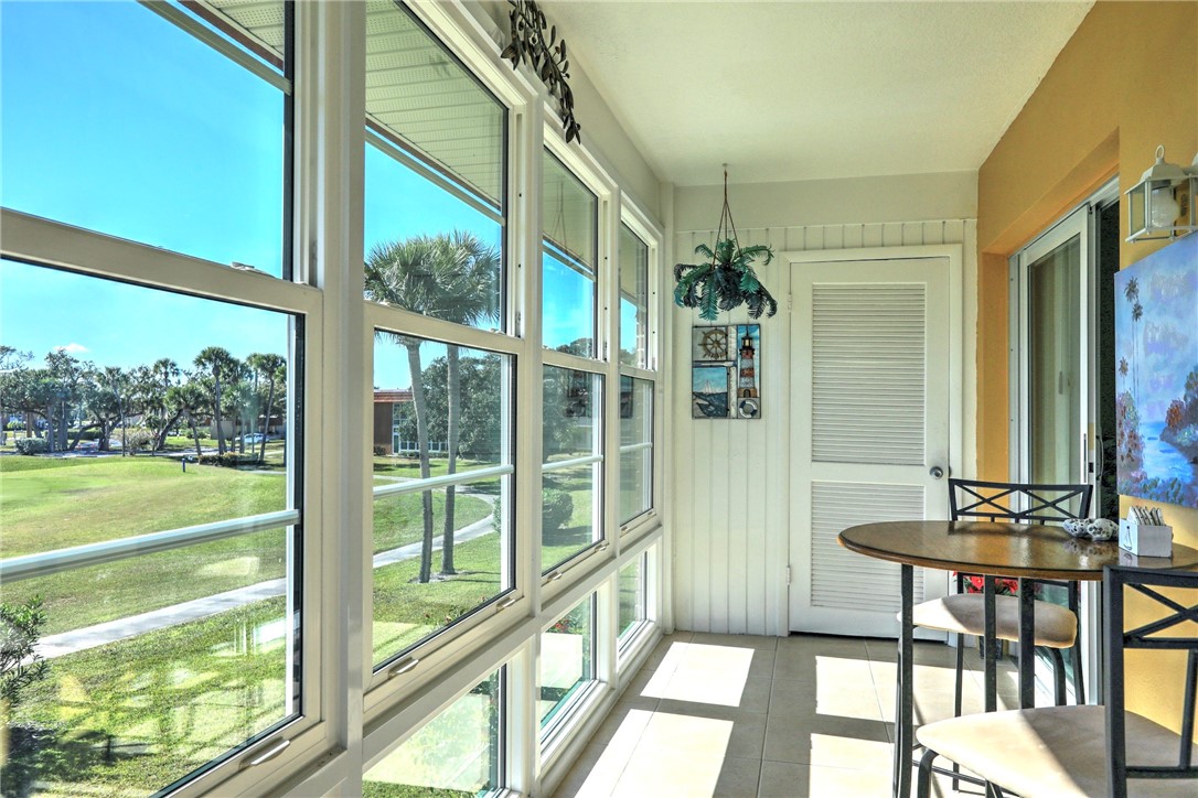 105 Spring Lake Court, Unit 207 Vero Beach, FL 32962 - Photo 21 of 34 a view of a porch with chairs and backyard