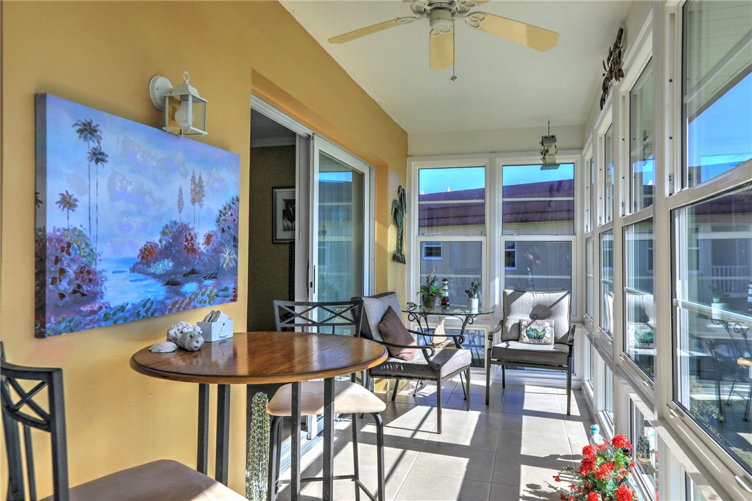 105 Spring Lake Court, Unit 207 Vero Beach, FL 32962 - Photo 22 of 34 a dining room with furniture and a chandelier