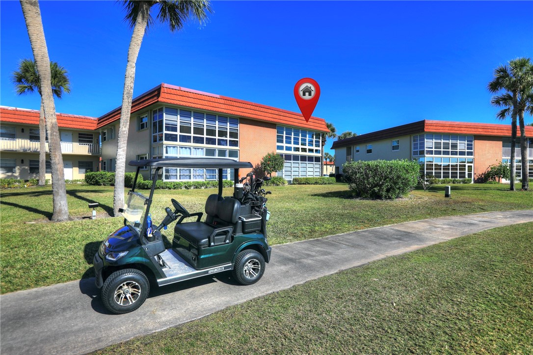 105 Spring Lake Court, Unit 207 Vero Beach, FL 32962 - Photo 30 of 34 a car parked in front of a house