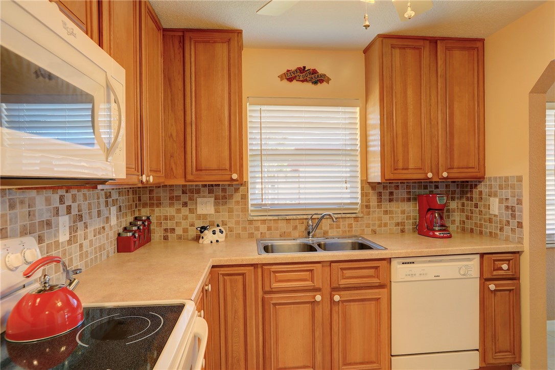 105 Spring Lake Court, Unit 207 Vero Beach, FL 32962 - Photo 4 of 34 a kitchen with sink a window and cabinets