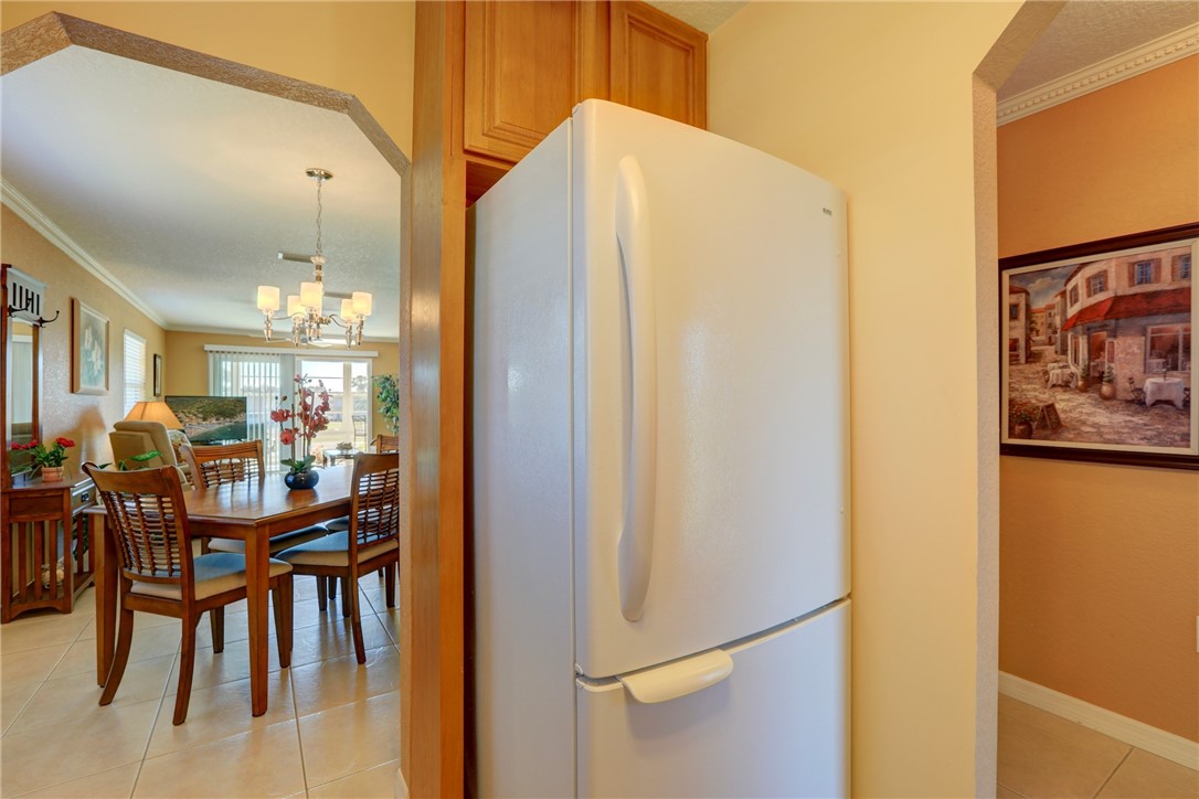 105 Spring Lake Court, Unit 207 Vero Beach, FL 32962 - Photo 6 of 34 a dining room with furniture and chandelier